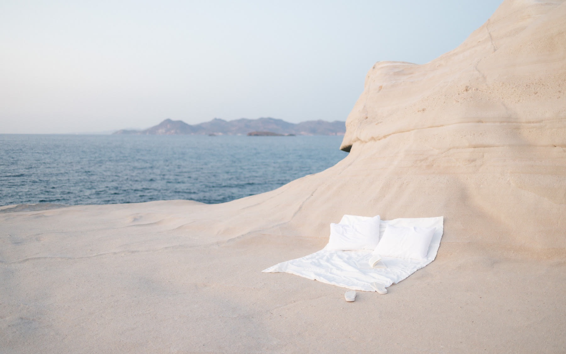 A bed by the sea in Milos, Greece